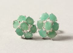 A PAIR OF SILVER AND EMERALD EARRINGS.