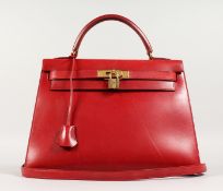 A VERY GOOD HERMES RED LEATHER HANDBAG with brass lock. No. 124. 13ins long x 10ins high, with short