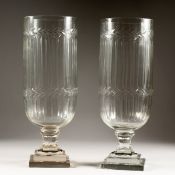 A LARGE PIR OF CUT GLASS STORM LANTERNS on square bases. 16ins high.