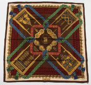 A HERMES SILK SCARF RICH REDS AND BLUE. 68ins x 68ins, in an orange Hermes box.