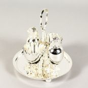 A CIRCULAR CHICK AND EGG FOUR CRUET, with two chick salt and peppers and two egg cups.