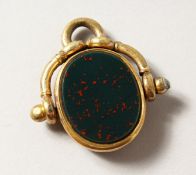 A GOLD MOUNTED SILVER FOB.
