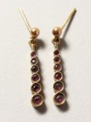 A PAIR OF 9CT GOLD RUBY EARRINGS.