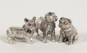 THREE CAST SILVER DOGS.