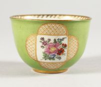 A MINIATURE MEISSEN CIRCULAR GREEN BOWL with panels of flowers. Cross swords mark. 2.25ins