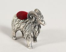 A CAST SILVER RAM PIN CUSHION.