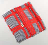 AN YVES SAINT LAURENT RED AND GREY SILK SCARF, 33ins x 33ins.