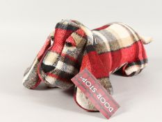 A TARTAN SAUSAGE DOG DOOR STOP.