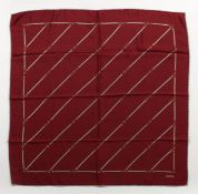 A GUCCI MAROON SILK SCARF, 26ins x 24ins.