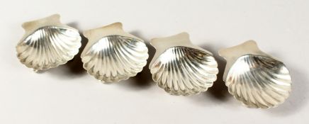A SET OF FOUR SILVER SHELL SALTS, STERLING MEXICO SILVER.