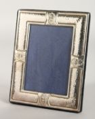 A HAMMERED PHOTOGRAPH FRAME with double shell border. 7ins x 5ins.