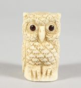 A CARVED BONE OWL FIGURE.