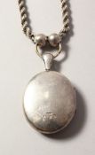 A VICTORIAN SILVER LOCKET and chain. Chester 1879.