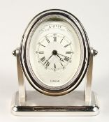 A GOOD ASPREY OF LONDON OVAL CHROME CLOCK with engine turned face. 5ins high.
