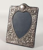 A HEART SHAPED PHOTOGRAPH FRAME with flowers. 7.25ins x 5ins.