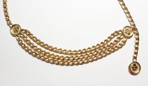 A LONG CHANEL GILT METAL BELT with CC medallion.