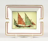 A HERMES, PARIS PORCELAIN ASHTRAY WITH A YACHT 7.75ins x 6.5ins.