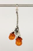 A SILVER AND AMBER PENDANT.