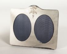 A DOUBLE OVAL PHOTOGRAPH FRAME with ribbon motif and basket of flowers. 7ins x 8.5ins.