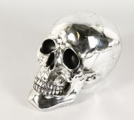 A LARGE SILVER PLATE SKULL. 10ins high.