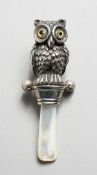 A SILVER NOVELTY OWL RATTLE.