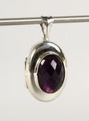A SILVER AND AMETHYST LOCKET.