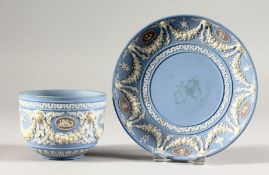 A WEDGWOOD JASPER WARE CUP AND SAUCER.