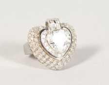 A SILVER AND CZ HEART SHAPED RING.