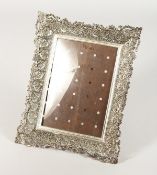 AN ISLAMIC SILVER UPRIGHT PHOTOGRAPH FRAME. 9.5ins x 7.5ins.