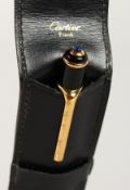 A CARTIER PEN in a leather case.