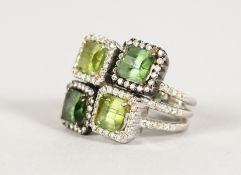 AN 18CT GOLD, DIAMOND AND FOUR STONE PERIDOT RING.