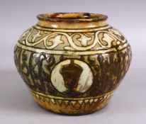A GOOD EARLY ISLAMIC POTTERY CALLIGRAPHIC VASE, with a green / brown glaze with bands of