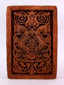 A CARVED WOODEN ISLAMIC / EGYPTIAN PLAQUE - carved with formal motif, 31cm x 22cm.