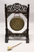 A 19TH CENTURY CARVED HARDWOOD DINNER GONG, the frame carved with bamboo, with the original