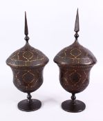 A FINE PAIR OF 19TH CENTURY PERSIAN QAJAR GOLD INLAID STEEL LIDDED URNS, with gold inlaid borders to