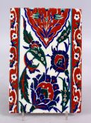 AN UNUSUAL RARE IZNIK POTTERY TILE, with decoration of floral motifs, 24cm x 16cm