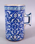 A LARGE OTTOMAN TURKISH POTTERY CUP, decorated with flora motif decoration, 20cm high x 18cm wide.