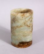 A SMALL CHINESE RUSSET CARVED JADE BRUSH WASHER, 9cm high x 6cm diameter.