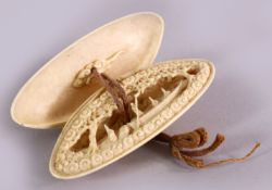 A JAPANESE MEIJI PERIOD CARVED IVORY NETSUKE - CLAMS DREAM - the top removing to reval a carved boat