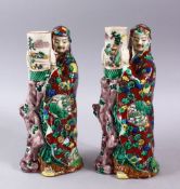 A PAIR OF JAPANESE MEIJI PERIOD KUTANI PORCELAIN CANDLE STICK FIGURES, in the form of two figures