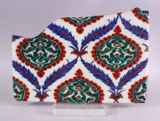 A LARGE TURKISH OTTOMAN IZNIK STYLE POTTERY TILE FRAGMENT, 34cm x 24cm.
