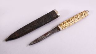 A 19TH CENTURY CARVED IVORY & WOOD SCANDINAVIAN PUKKO, the handle carved with an array of flora