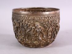 A FINE 19TH CENTURY BURMESE SILVER EMBOSSED BOWL, decorated with figures in panels, with animals and