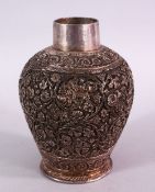 A 19TH CENTURY INDIAN SILVERED FLORAL VASE, carved with flora, the base signed, 13cm high.