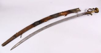 A 19TH CENTURY ISLAMIC INDIAN SIGNED TULWAR SWORD, with its metal mounted scabbard, blade signed,