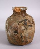 AN EARLY ROMAN STYLE POTTERY VASE, with relief decoration of a face, 14cm high x 12cm