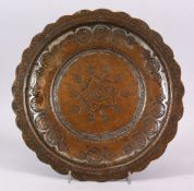 A 19TH CENTURY ISLAMIC TURKISH TINNNED COPPER ENGRAVED DISH, the dish carved with formal floral