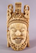 A FINELY CARVED 19TH CENTURY CHINESE IVORY MASK - depicting a warrior, with headdress, dragons and