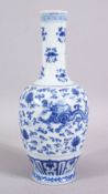 A CHINESE MING STYLE BLUE & WHITE PORCELAIN DRAGON VASE, decorated with two dragons amongst lotus,