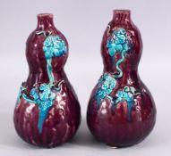 A PAIR OF POSSIBLY 19TH CENTURY CHINESE AUBERGINE GLAZED PORCELAIN DOUBLE GOUORD VASES, each with an